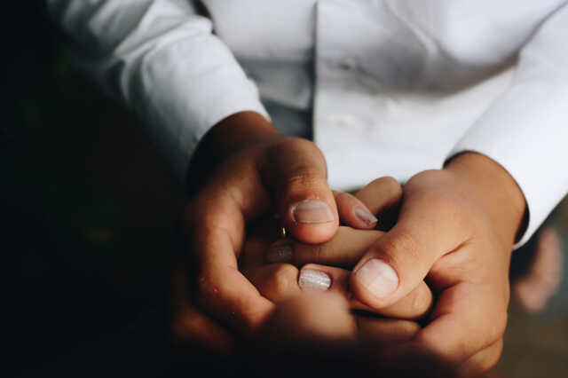 holding hands praying together