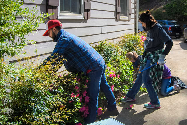 volunteers weeding flower beds for goshen valley